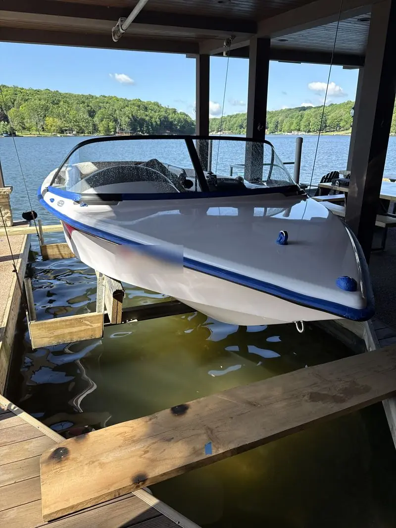Boat bow with blue masking tape along the trim before polishing