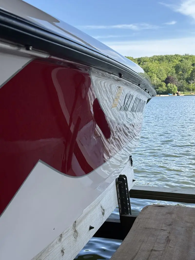 Close-up of the polished red and white hull with a deep gloss