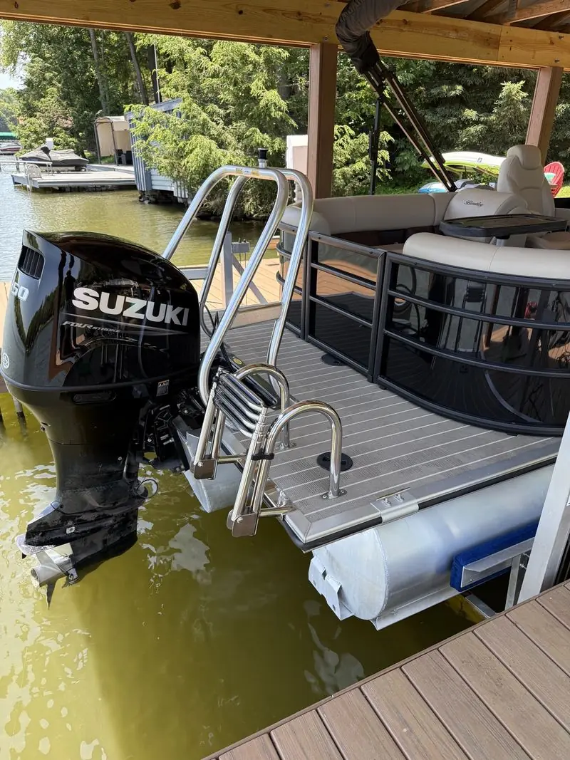 The same stern and outboard after detailing, with a cleaner, glossier motor cowl